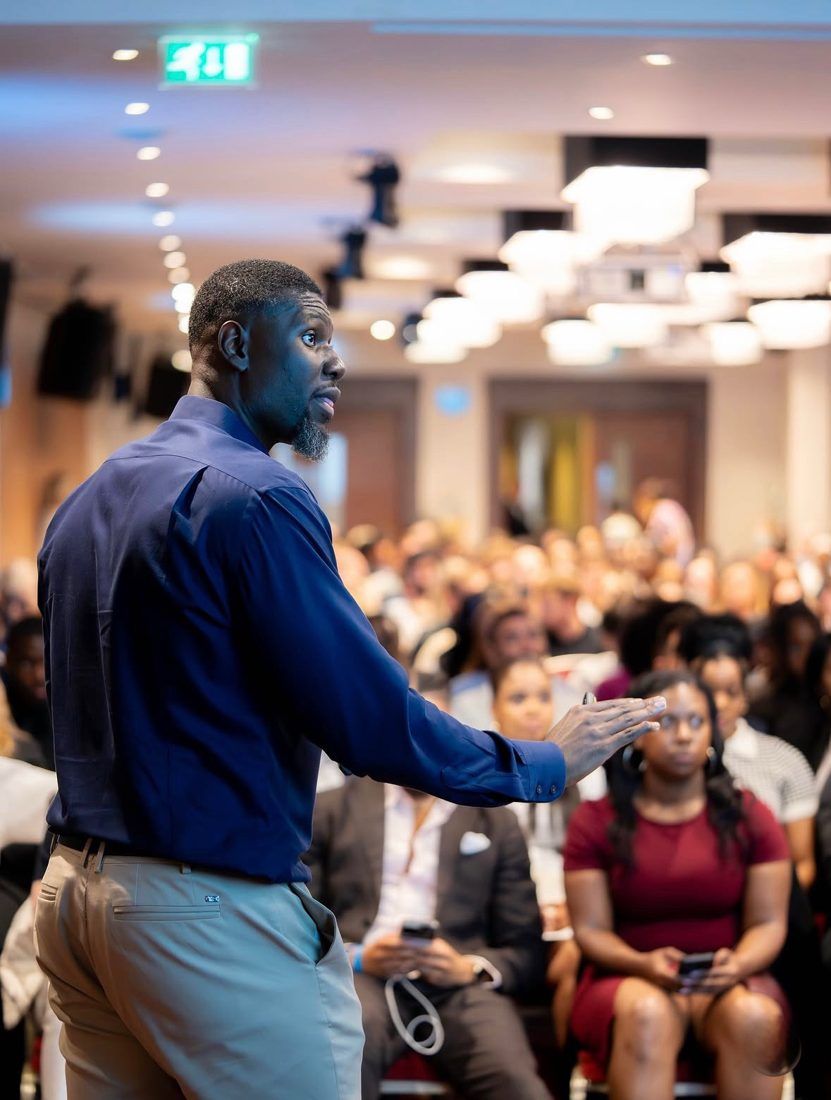 Jason Agbodza speaking to a full room