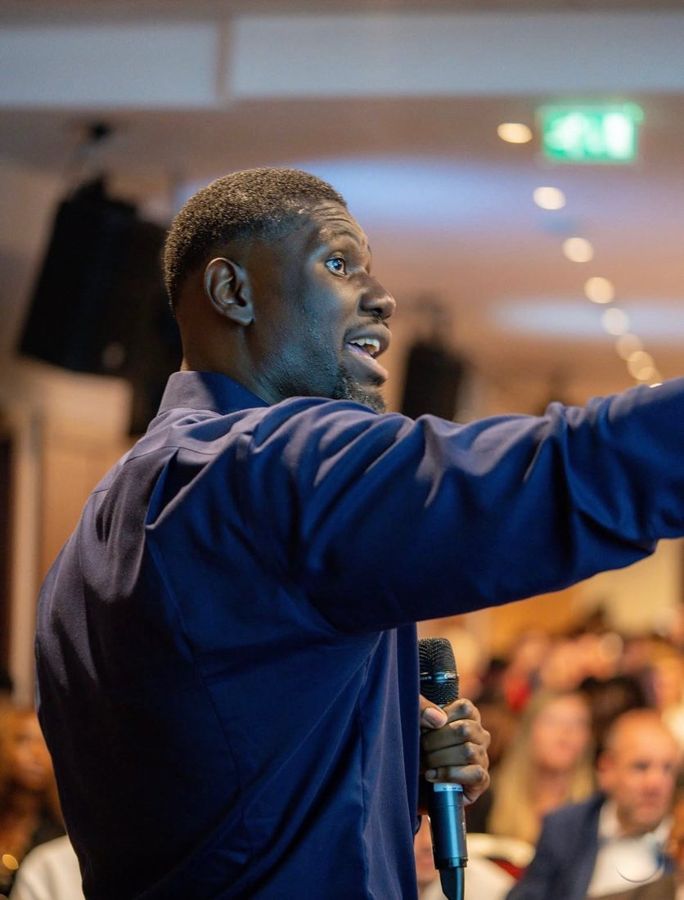 Jason Agbodza pointing to the audience while speaking