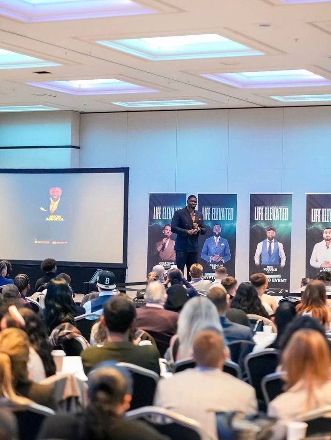 Jason Agbodza on stage in front of a large audience